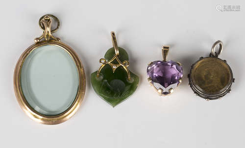 A gold pendant, claw set with a heart shaped amethyst, length 2.8cm, a gold mounted oval pendant