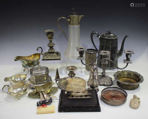 A collection of assorted plated items, including a chamberstick and a glass claret jug.Buyer’s