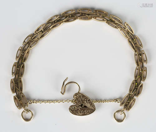 A 9ct gold decorated oval link bracelet on a 9ct gold heart shaped padlock clasp, length 18cm.