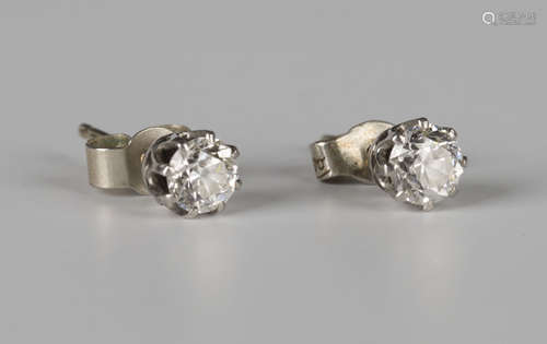 A pair of diamond single stone earstuds, each claw set with a circular cut diamond, with post and