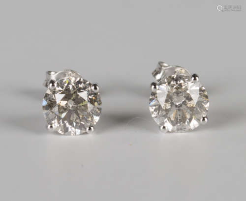 A pair of 18ct white gold and diamond single stone earstuds, each claw set with a circular cut