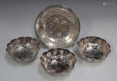 An Egyptian silver circular dish, engraved with a central script and star motif within foliate