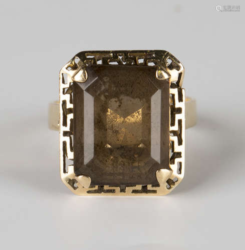 A gold ring, claw set with a cut cornered rectangular step cut smoky quartz, detailed '18K', ring