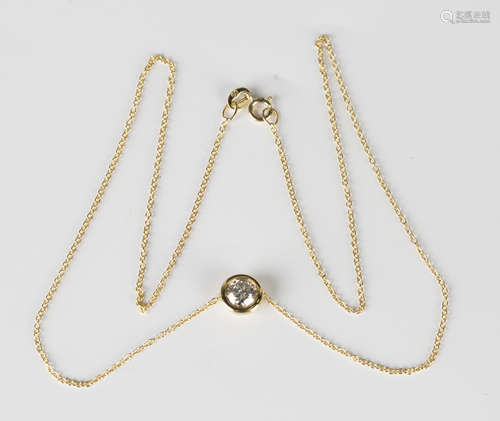 A gold and diamond single stone pendant, collet set with a circular cut diamond, detailed '750',