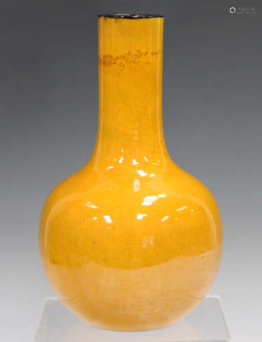 A Chinese yellow glazed bottle vase, mark of Kangxi but later Qing dynasty, the globular body