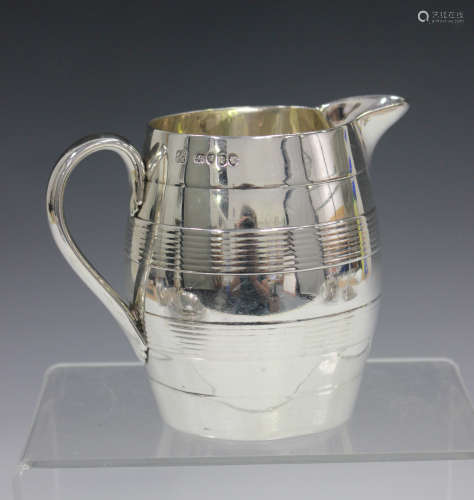 A Victorian silver milk jug of coopered barrel form with reeded horizontal banding, London 1858 by