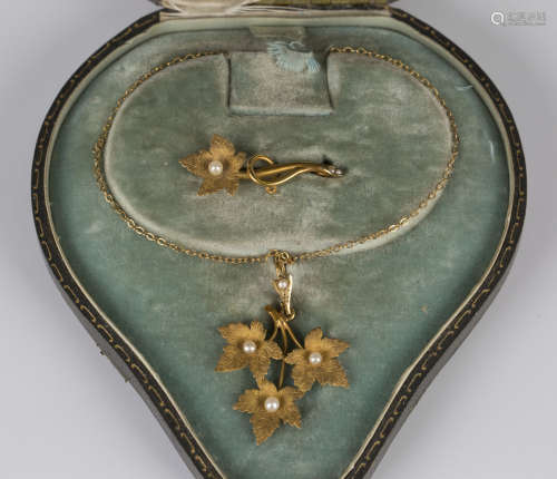 A gold and seed pearl pendant and matching brooch, circa 1900, the pendant designed as three leaves,