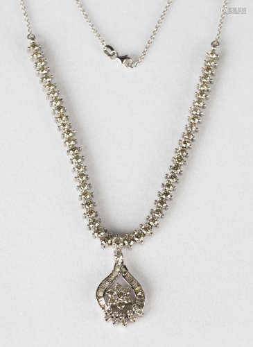 An 18ct white gold and diamond pendant necklace, the pendant of floral and scrolling design, mounted