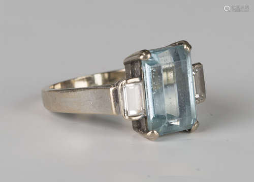 An 18ct white gold, aquamarine and diamond three stone ring, claw set with the cut cornered