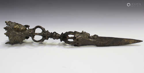 A Tibetan brown patinated bronze phurba, probably late 19th/early 20th century, the handle cast with