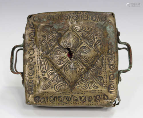 A Tibetan brass gau amulet box, 19th century, of square form with engraved foliate decoration, the