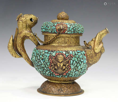 A Tibetan copper and brass teapot, 20th century, with lion handle, the embossed body with