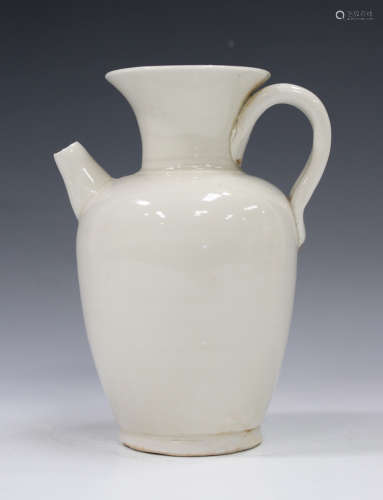 A Chinese Ding ware jug, the ovoid body with flared neck, loop handle and short spout, covered in