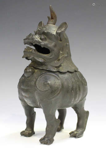 A Chinese brown patinated bronze Buddhistic lion censer, Qing dynasty, the beast modelled standing