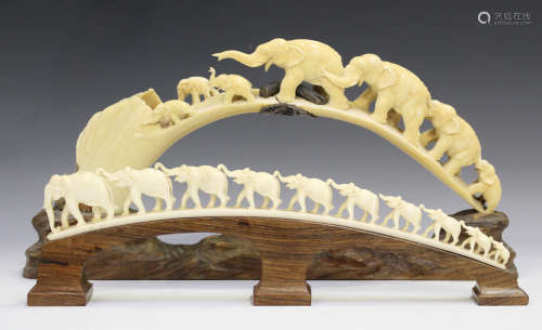 A Japanese elephant train ivory tusk carving, Meiji period, carved and pierced with seven elephants,