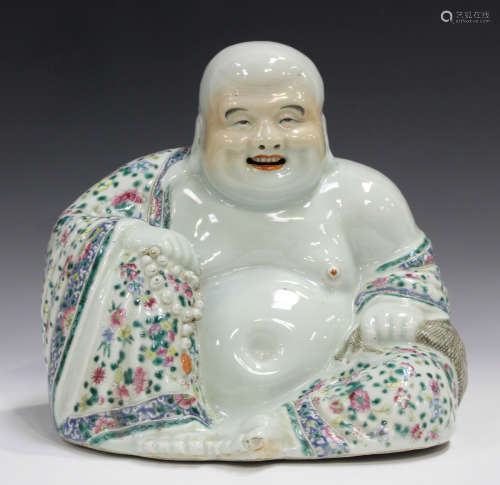 A Chinese famille rose enamelled porcelain figure of a seated Buddha, early 20th century, modelled