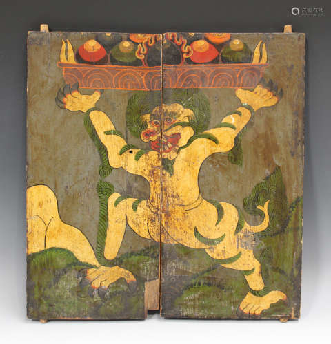 A pair of Tibetan painted wood doors, late 19th century, decorated with a deity, total 42.5cm x