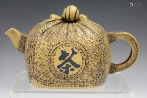 A Chinese buff coloured Yixing stoneware teapot, 20th century, modelled as a tied sack with textured