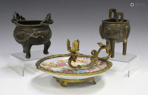 A Chinese brown patinated bronze tripod censer, late Qing dynasty, the body cast in relief with