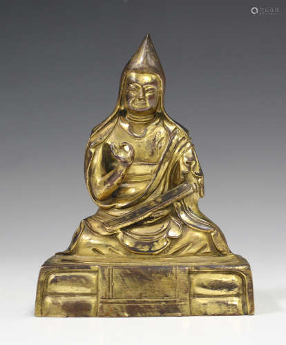 A Sino-Tibetan gilt bronze figure of a lama, probably late Qing/20th century, modelled seated