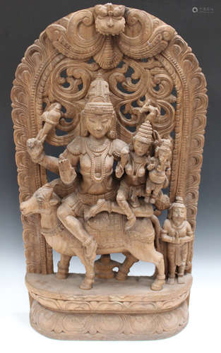 An Indian carved and pierced hardwood panel, 20th century, modelled with Shiva, Parvati and Ganesh