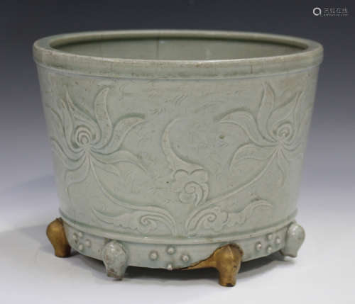 A Chinese celadon glazed censer, probably Ming dynasty, of cylindrical tapering form, carved in