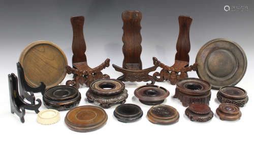 A collection of Chinese hardwood stands, late 19th century and later, including a pair of dish