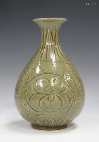 A Chinese Longquan celadon glazed vase, 15th century style but later, the pear form body carved in