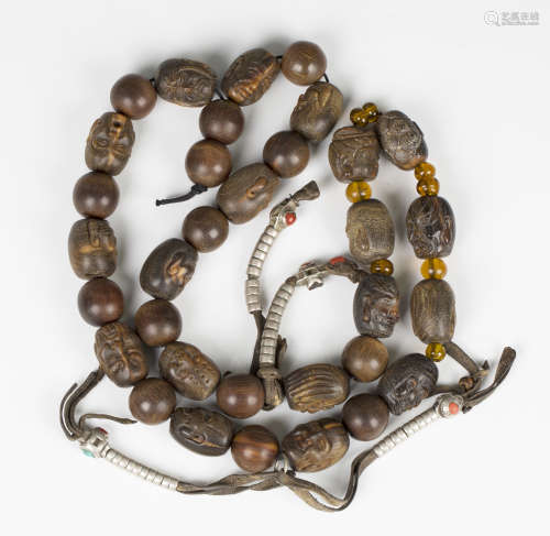 A Sino-Tibetan carved rhinoceros horn bead necklace, Qing dynasty, comprising eighteen beads