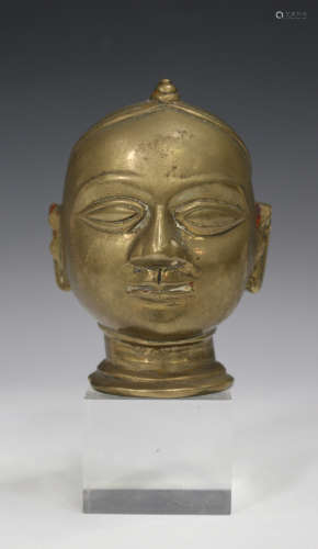 An Indian bronze head of a deity, 18th/19th century, modelled with eyes closed, height 11cm.Buyer’