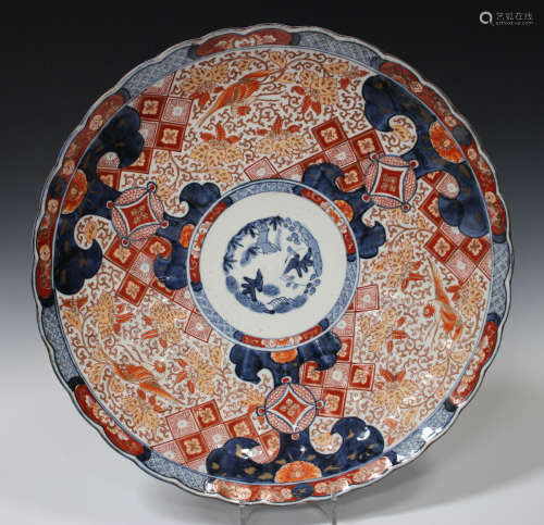 A Japanese Imari porcelain charger, Meiji period, of fluted circular form, the centre painted in