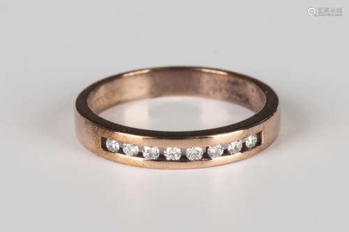 A 9ct rose gold and diamond half eternity ring, mounted with a row of eight circular cut diamonds,