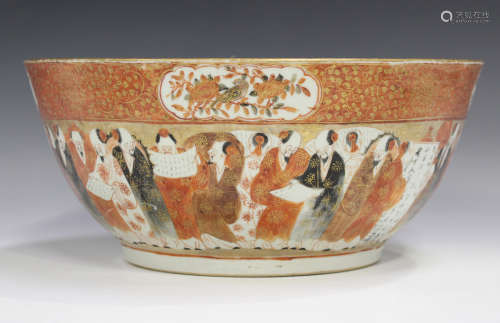 A Japanese Kutani porcelain punch bowl, Meiji period, painted and gilt inside and out with a
