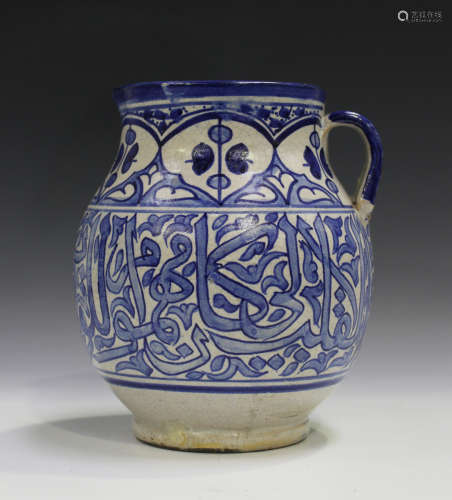 An Islamic blue and white tin glazed earthenware jug, early to mid-20th century, the stout