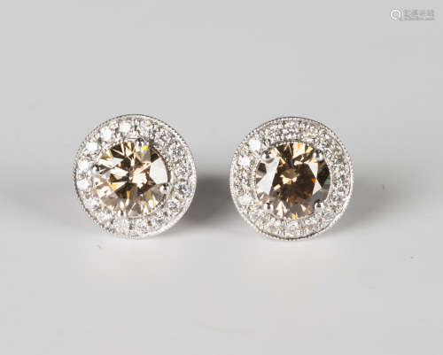 A pair of 18ct white gold, fancy brown diamond and diamond cluster earrings, each claw set with a