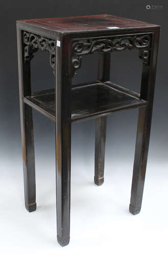 A Chinese hardwood stand, late Qing dynasty, the rectangular panelled top above a pierced scroll