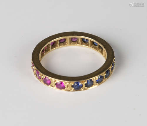 A gold, synthetic ruby and synthetic sapphire eternity ring, ring size approx M, with a case.Buyer’s