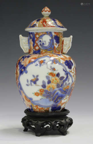 A Japanese Fukagawa Imari porcelain vase and cover, Meiji period, painted with panels of flowers,