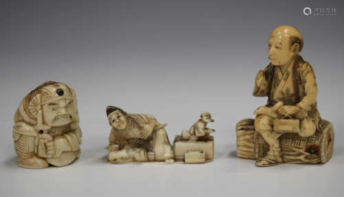 A Japanese ivory okimono carving, Meiji period, modelled as a seated scholar and child, inlaid