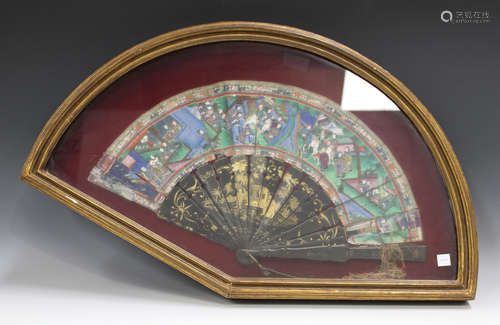 A Chinese Canton export lacquer folding fan, mid to late 19th century, the lacquer guards and