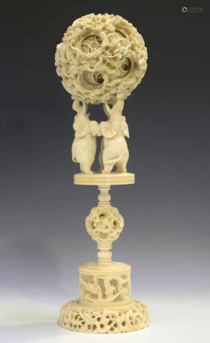 A Chinese Canton export ivory concentric puzzle ball and stand, late Qing dynasty, the outer case