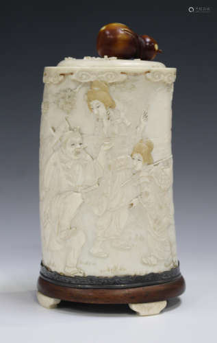 A Japanese carved ivory tusk jar and cover, Meiji period, carved in low relief with a continuous