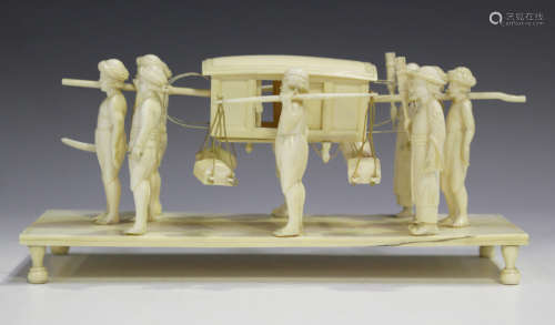 An Indian carved ivory group, late 19th century, modelled as a procession of ten attendants and a