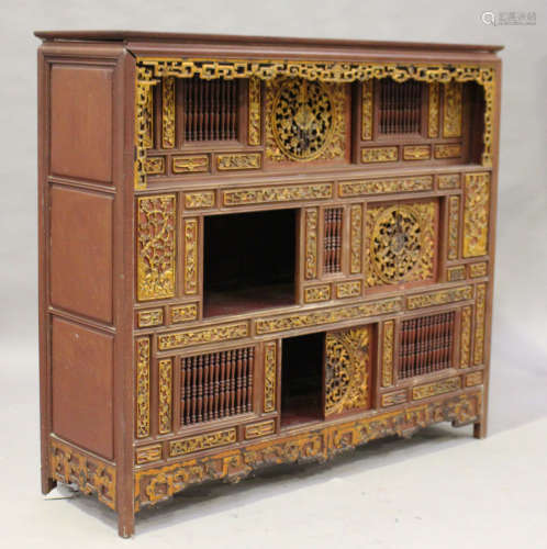 A Chinese iron red lacquered softwood cabinet, late Qing dynasty, fitted with an arrangement of