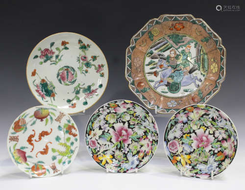 A pair of Chinese famille rose millefleurs black ground porcelain saucer dishes, mark of Qianlong