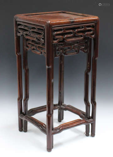 A pair of Chinese hardwood graduated occasional tables, late Qing dynasty, each square panelled