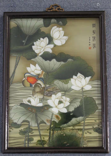 A Chinese reverse painting on glass, 20th century, depicting a pair of mandarin ducks on a lily