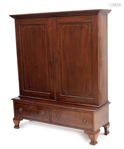 Large mahogany bookcase, the moulded cornice over two panelled and boxwood inlaid doors enclosing