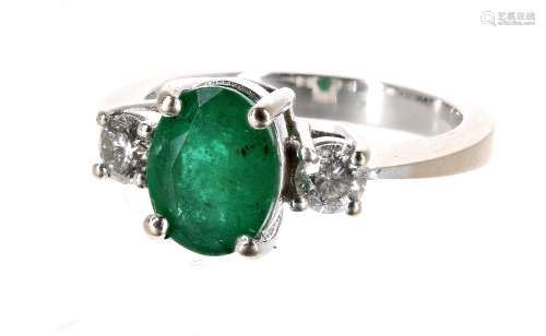 14ct white gold emerald and diamond three stone ring, the oval emerald 1.50ct approx, flanked with
