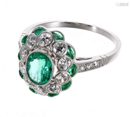 Attractive platinum, emerald and diamond dress ring, set with a central oval shaped emerald,